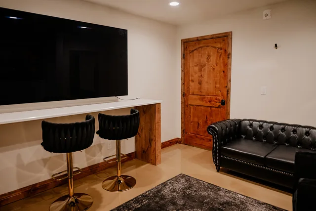 The Ember Suite lounge with a leather sofa and TV