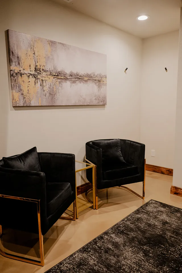 Black leather club chairs in the Ember Suite